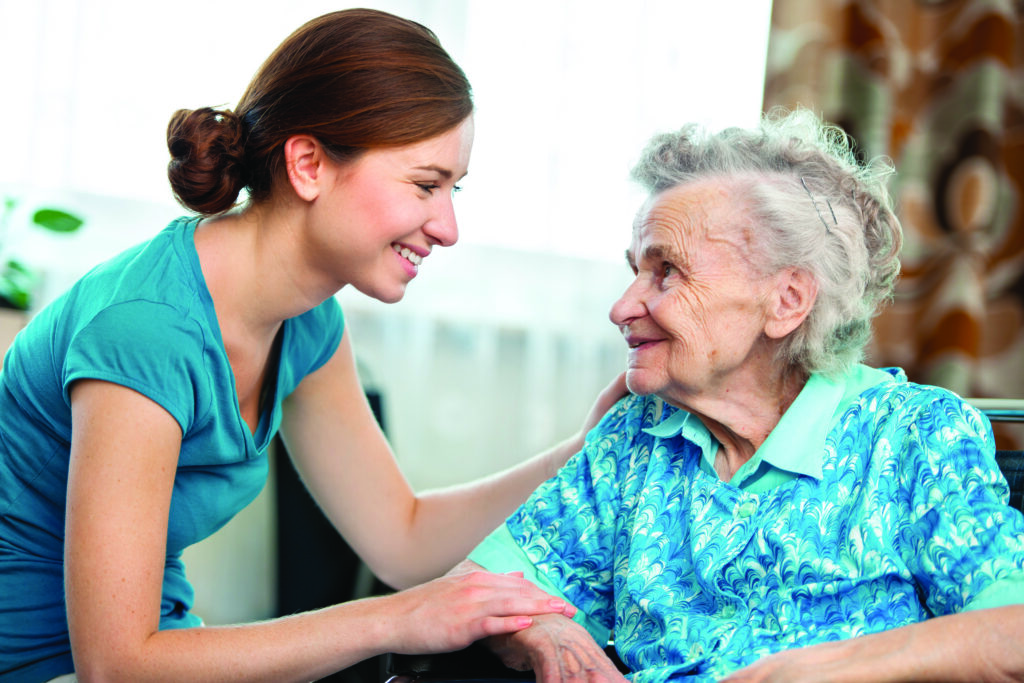 Senior woman with her caregiver at home
